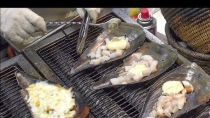 'Iconic Korea Street Food, Seoul. Melting Cheese over Baked Scallops and Octopus Balls'