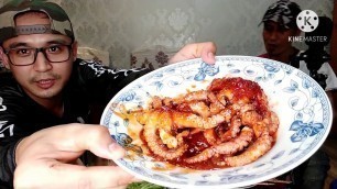 'Wiro and his nephew are eating chinese food lobster and octopus.'