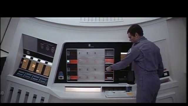 '2001: A space Odyssey. Dave Bowman removes hot food from the oven.'