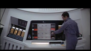 '2001: A space Odyssey. Dave Bowman removes hot food from the oven.'