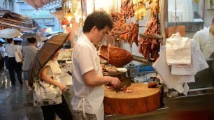 'Hong Kong Street Food. The Seller of Roasted Meat. Action in the Kitchen.'